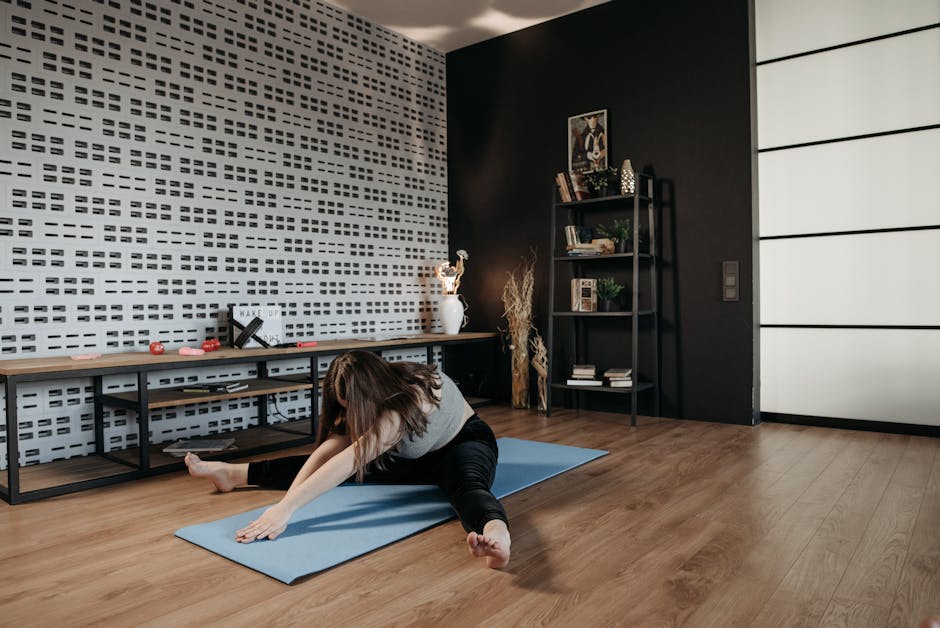 A woman performing a stretching exercise on a yoga mat in a stylish indoor space.