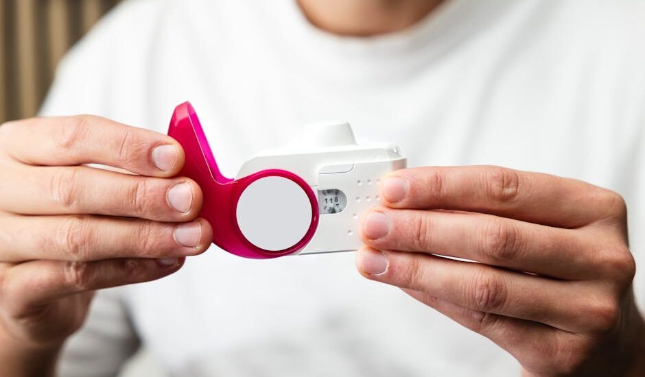 Close-up of hands holding a peak flow meter for respiratory health monitoring.