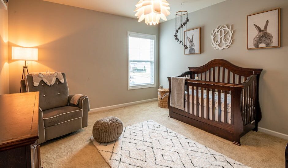 A cozy baby bedroom with a wooden crib, armchair, and soft lighting, illustrating an ideal space for using top humidifiers in 2026.