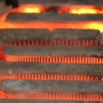 Detailed view of a glowing electric heating element with a coiled structure emitting heat.