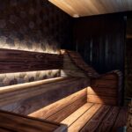 Contemporary wooden infrared sauna with geometric wall panels and soft lighting, illustrating top home sauna options for 2026