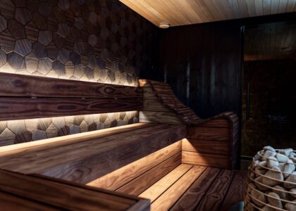 Contemporary wooden infrared sauna with geometric wall panels and soft lighting, illustrating top home sauna options for 2026
