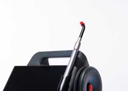 Close-up of a dental laser machine with a screen and handpiece, showcasing modern medical technology.