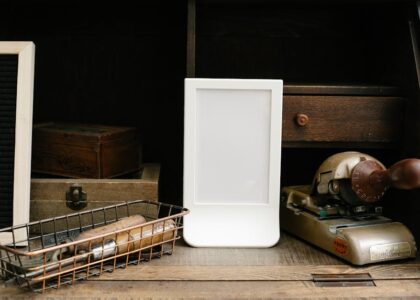 A white light therapy lamp sits on a wooden desk among vintage office items, illustrating options for dementia care lighting.