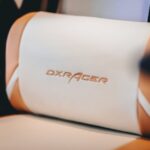 Lumbar support cushion attached to a car seat, showing the DXRacer logo, for best car lumbar support cushions guide.