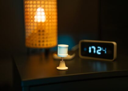 A smart home nightstand featuring a motion sensor, digital clock, and warm-toned lamp, creating a cozy ambiance.