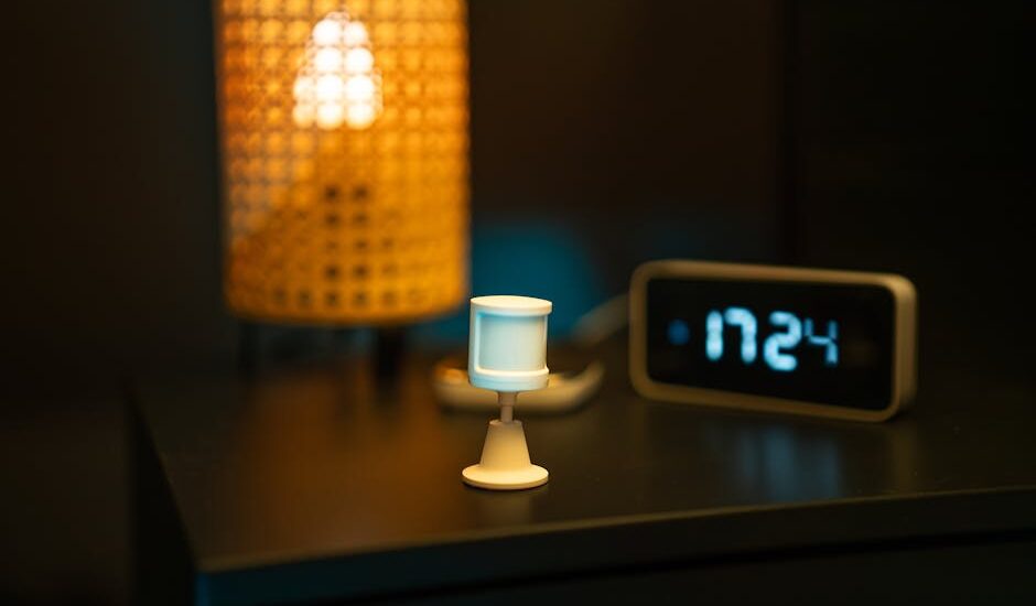 A smart home nightstand featuring a motion sensor, digital clock, and warm-toned lamp, creating a cozy ambiance.
