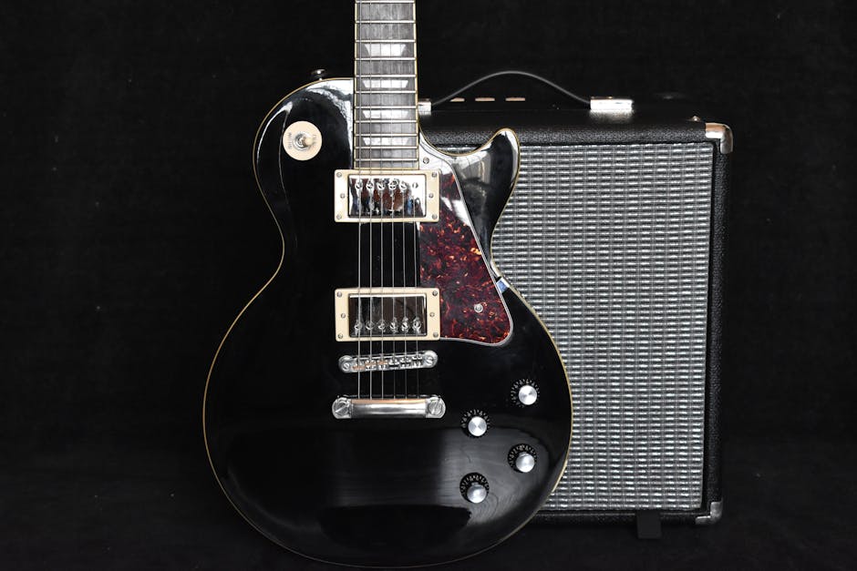A sleek black electric guitar and amp captures the essence of modern rock music gear.