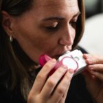 Close-up of a woman using an inhaler for respiratory health management.
