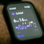 Close-up of a wearable sleep tracking device on a wrist, showing detailed sleep data, for kids’ sleep monitor guide.