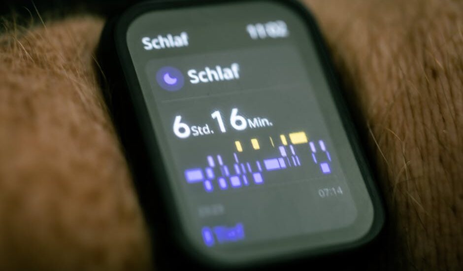 Close-up of a wearable sleep tracking device on a wrist, showing detailed sleep data, for kids’ sleep monitor guide.
