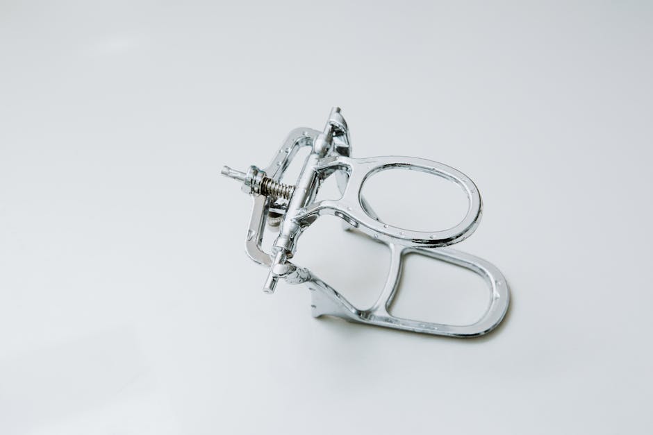 From above of metal dental occluder used for creating denture placed on white background