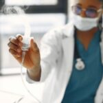 difference between steam inhalation and nebulization — Close-up of a healthcare worker holding a nebulizer, showing focus on medical equipment.