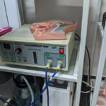 Electric nasal irrigator machine with control panel and a nasal anatomy model, illustrating devices discussed in the guide