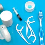 A variety of dental hygiene tools arranged neatly on a vibrant blue surface, showcasing oral care essentials.