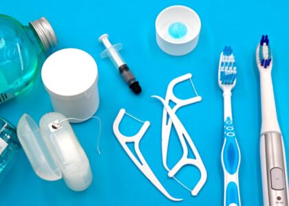 A variety of dental hygiene tools arranged neatly on a vibrant blue surface, showcasing oral care essentials.