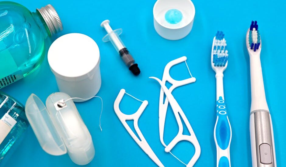 A variety of dental hygiene tools arranged neatly on a vibrant blue surface, showcasing oral care essentials.
