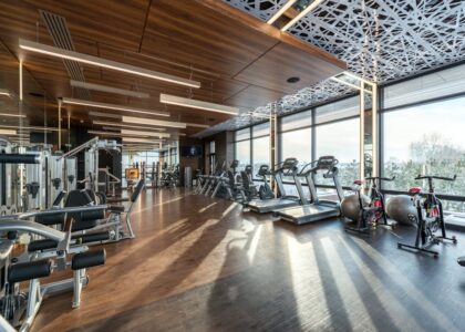 Spacious gym with treadmills, elliptical machines, and stationary bikes, illustrating options for fitness equipment comparison.