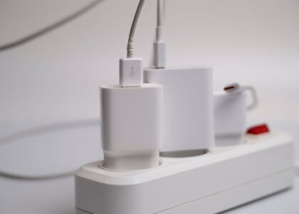 how to charge electric heating pad — Minimalist composition of electronic device chargers connected to a power strip indoors.