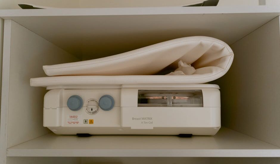 A breast pump machine with control dials and a folded pad on a shelf, illustrating breast pump options for new parents.