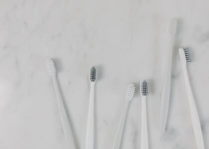 Top view of toothbrushes on a minimalist marble surface, perfect for hygiene themes.