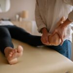 Close-up of a foot massage therapy session, showcasing relaxation and wellness indoors.