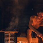 A man enjoying a warm and relaxing sauna session, embracing Nordic design.