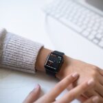 Person wearing an Apple Watch with a health tracking screen, relevant to comparing medical alert systems and smartwatches