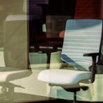 Two ergonomic office chairs with supportive seat cushions, illustrating options for posture corrector seat cushions in a store display.