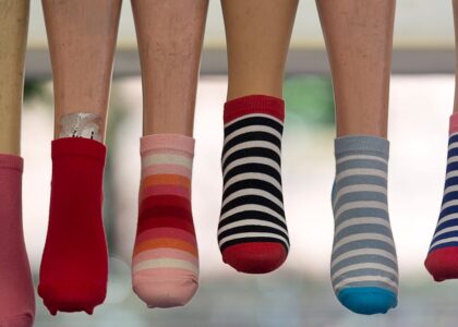 A vibrant array of striped socks displayed on mannequin legs, showcasing fashion variety.