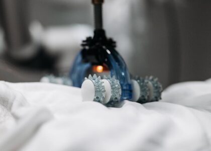 vibration therapy vs percussion therapy — High-tech massage gadget resting on white fabric, showcasing innovation in relaxation technology.