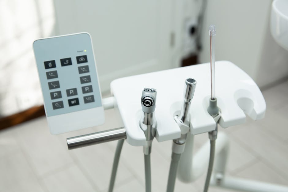 Close-up of modern dental tools and control panel in a clinic, showcasing professional equipment.