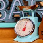 Close-up of a vintage blue kitchen scale with fruits in a modern setting.
