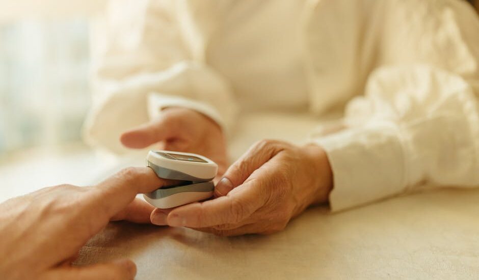 Person using a fingertip pulse oximeter to measure blood oxygen, illustrating normal pulse oximeter readings in practice.