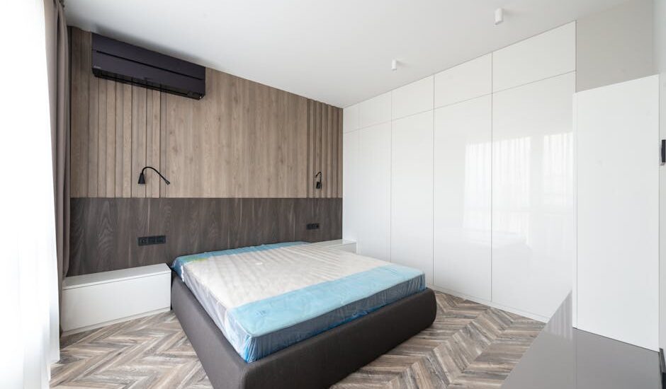 Spacious modern bedroom with minimalist design and wooden accents.