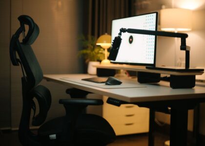 A cozy home office featuring an ergonomic chair, computer setup, and ambient lighting for a productive environment.