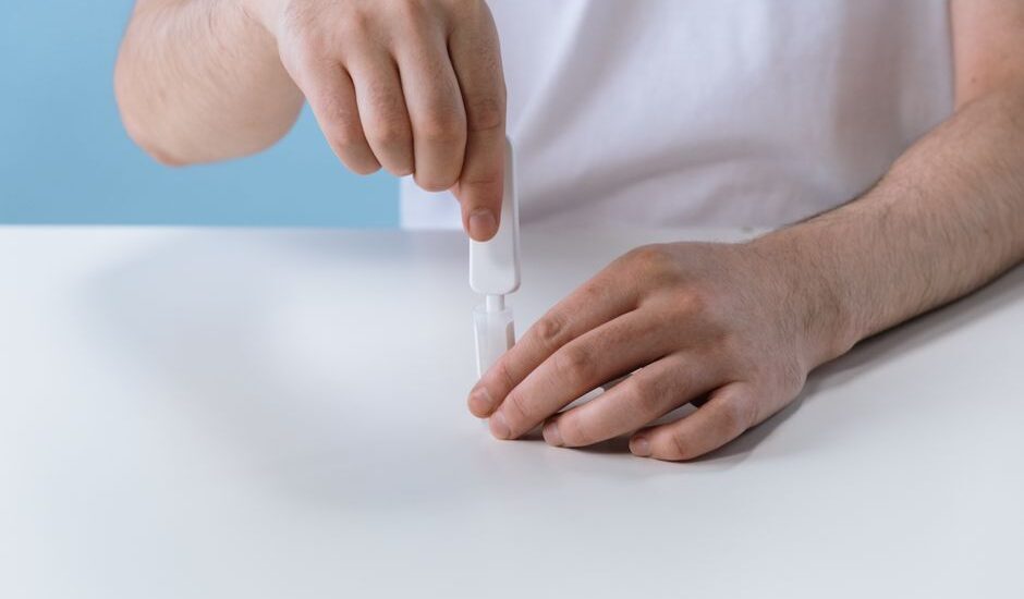 A person using a home cholesterol test kit, relevant to test accuracy discussion.