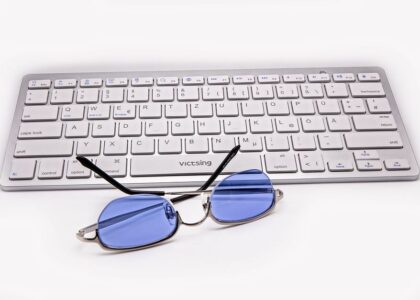 Blue light glasses resting on a keyboard, relating to blue light benefits.