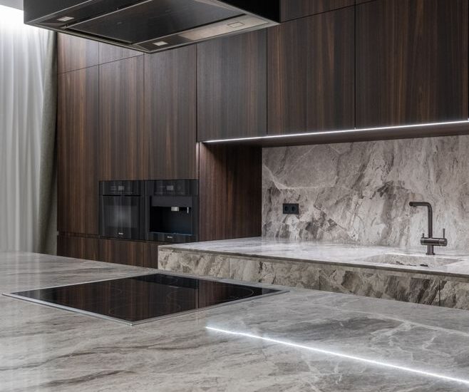 A sleek kitchen countertop featuring an electric pill crusher among modern appliances.