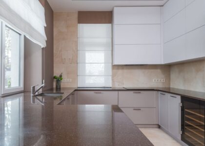 A sleek kitchen featuring a dark countertop and minimalist cabinetry, relevant to UV cleaning water bottles.