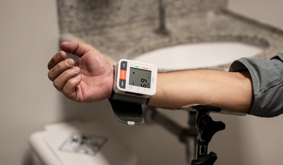 A person checks their blood pressure with a monitor on their wrist, relevant to blood pressure monitors reviews.