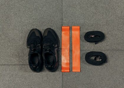 Image showing resistance bands and tubes alongside athletic shoes, illustrating the differences between them.