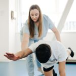 A healthcare professional assists a patient during a physical assessment, relevant to digital dynamometer pricing.