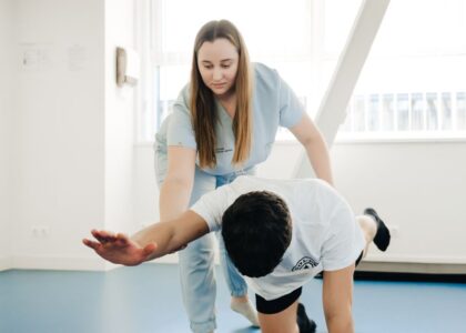A healthcare professional assists a patient during a physical assessment, relevant to digital dynamometer pricing.