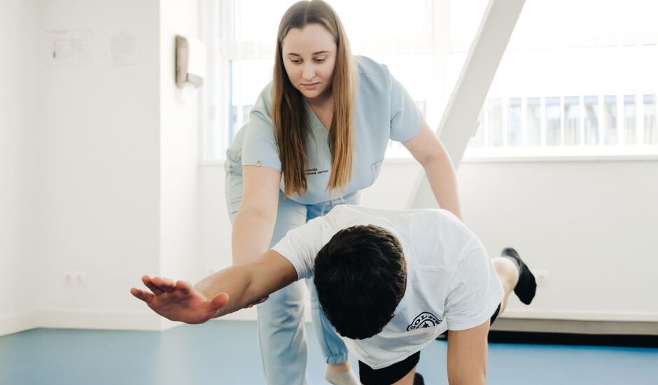 A healthcare professional assists a patient during a physical assessment, relevant to digital dynamometer pricing.