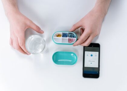 A digital pill organizer with compartments and a smartphone app for reminders.