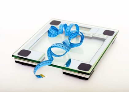 A digital scale with a measuring tape, illustrating the comparison of digital and analog scales.