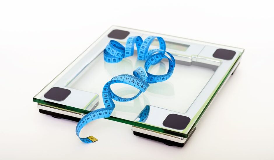 A digital scale with a measuring tape, illustrating the comparison of digital and analog scales.