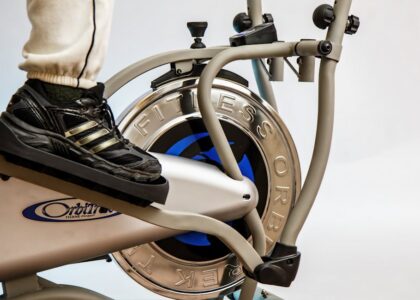 Close-up of a foot on an elliptical trainer, relevant to elliptical trainer vs stair climber article.