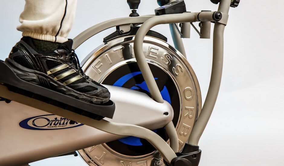 Close-up of a foot on an elliptical trainer, relevant to elliptical trainer vs stair climber article.